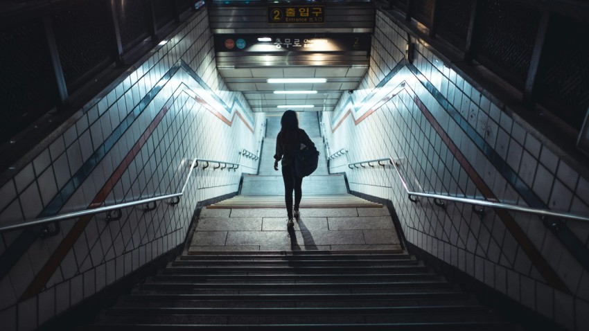 man in black jacket walking on the stairs 1r