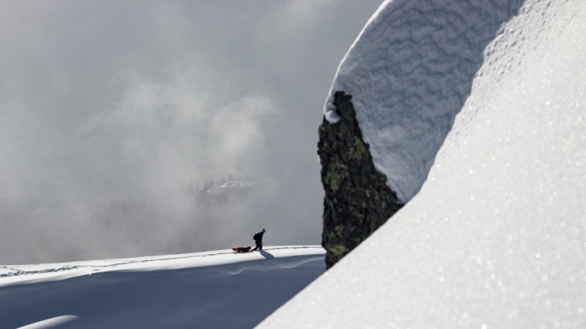 a person standing on top of a snow covered slope