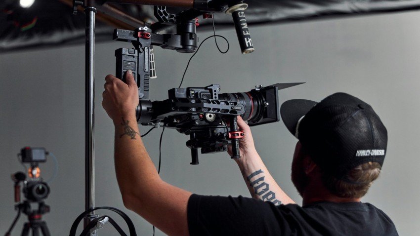 a man holding a camera in front of a camera Sh 7ntDx