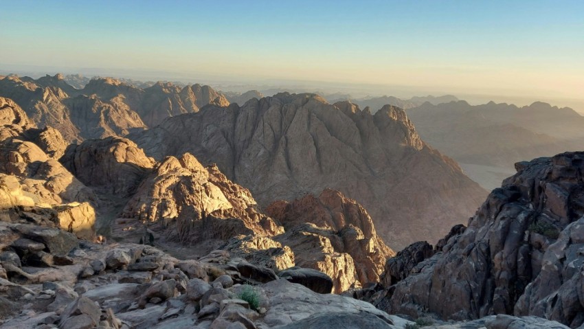 a view of a rocky mountain range at sunset