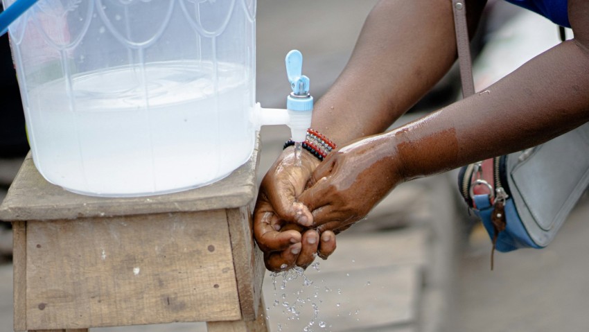 person holding white plastic bottle