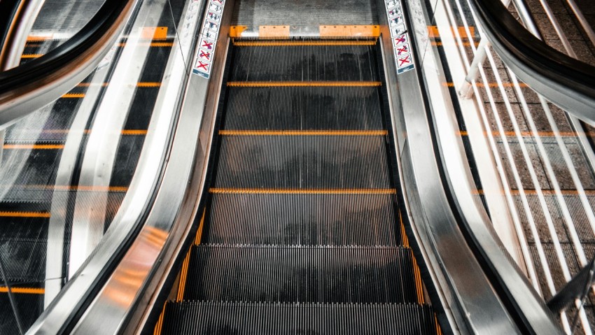 black and brown escalator in close up photography FDE2