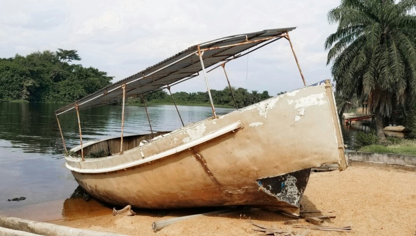 brown and white boat on brown sand during daytime