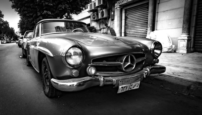 a black and white photo of a classic car