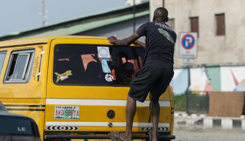 a man standing on the back of a yellow van