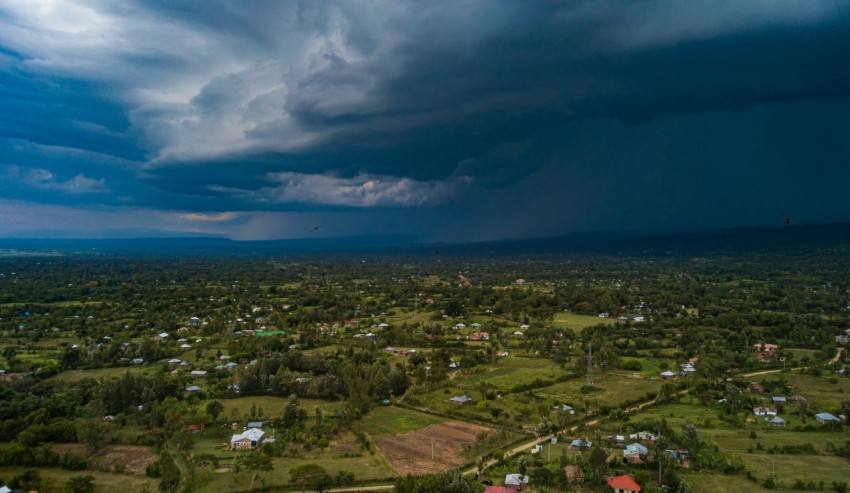 an aerial view of a small town under a cloudy sky