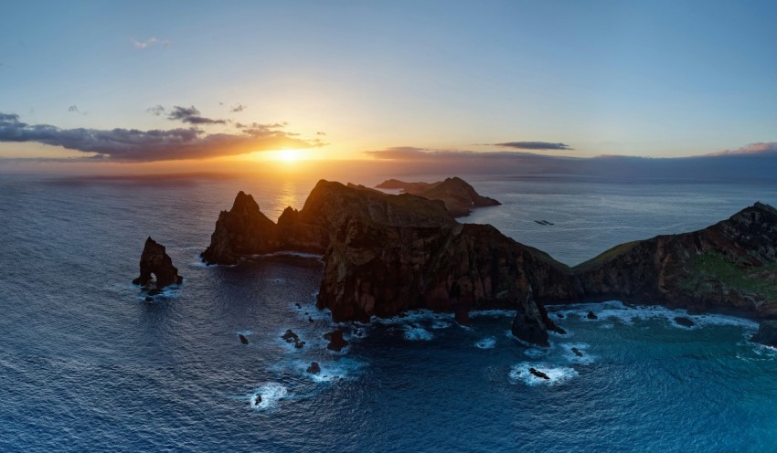 an aerial view of a sunset over the ocean