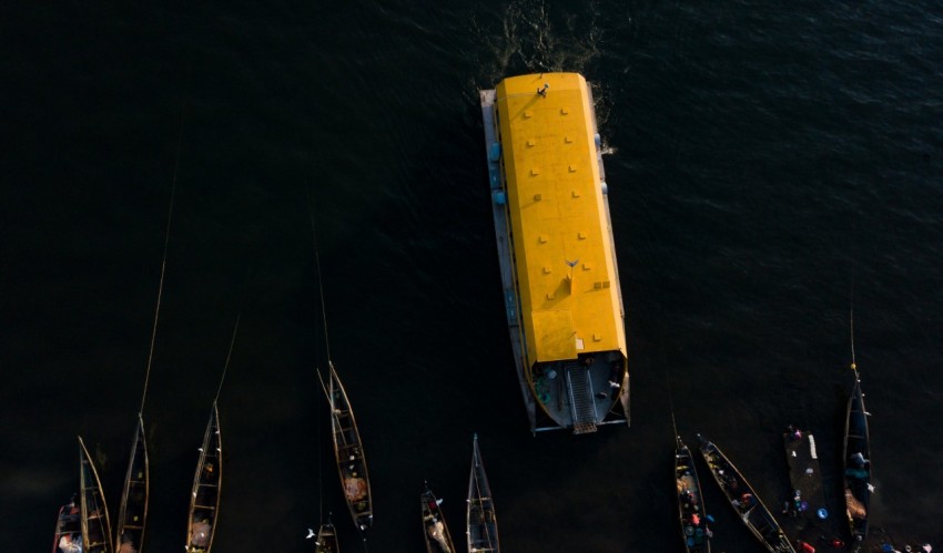 a yellow boat floating on top of a body of water