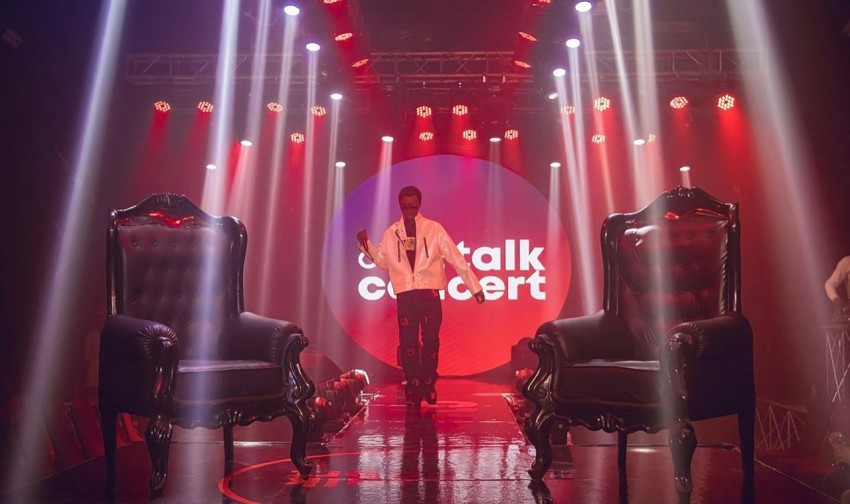 a man standing on a stage in front of chairs