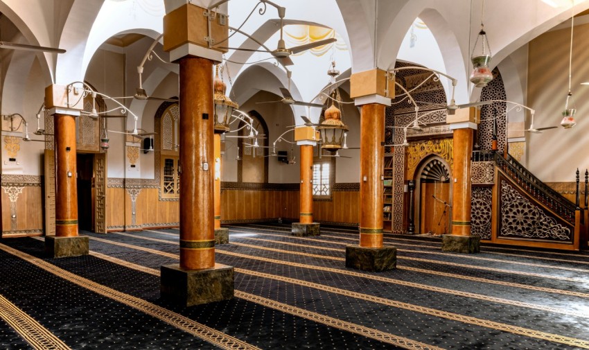 a large room with columns and a staircase