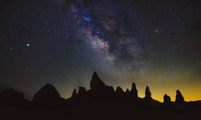 silhouette of mountain under starry night