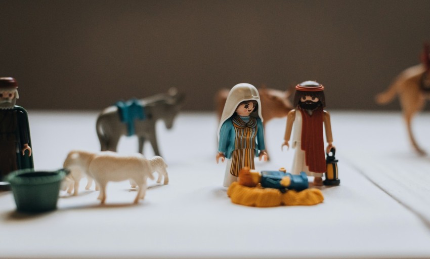 a table topped with figurines of people and animals I