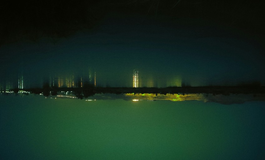 a view of a city at night from the water