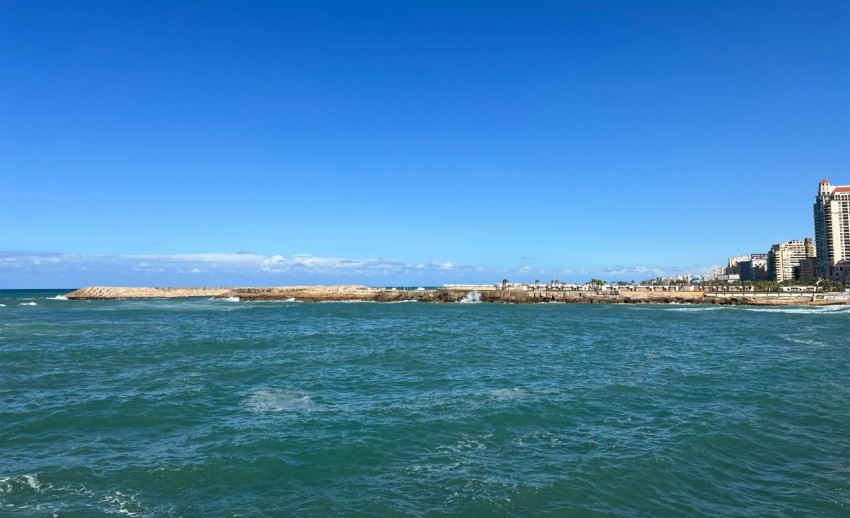 a body of water with buildings in the background