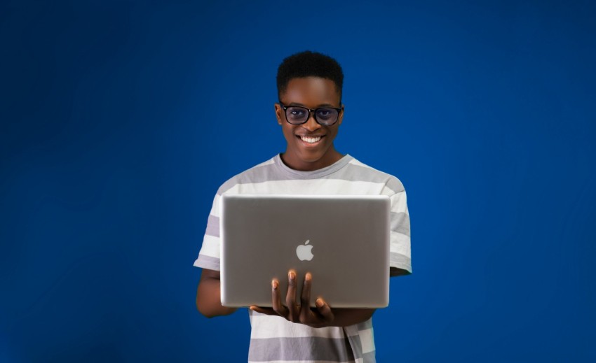 a man holding a laptop