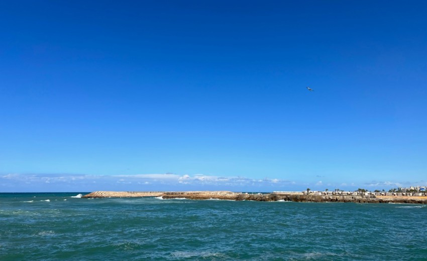 a large body of water with a sky background