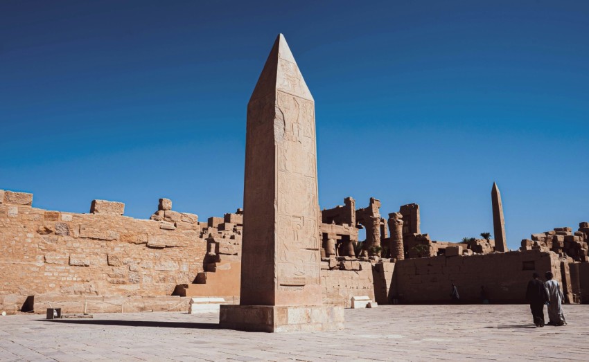 a group of people standing in front of a stone structure