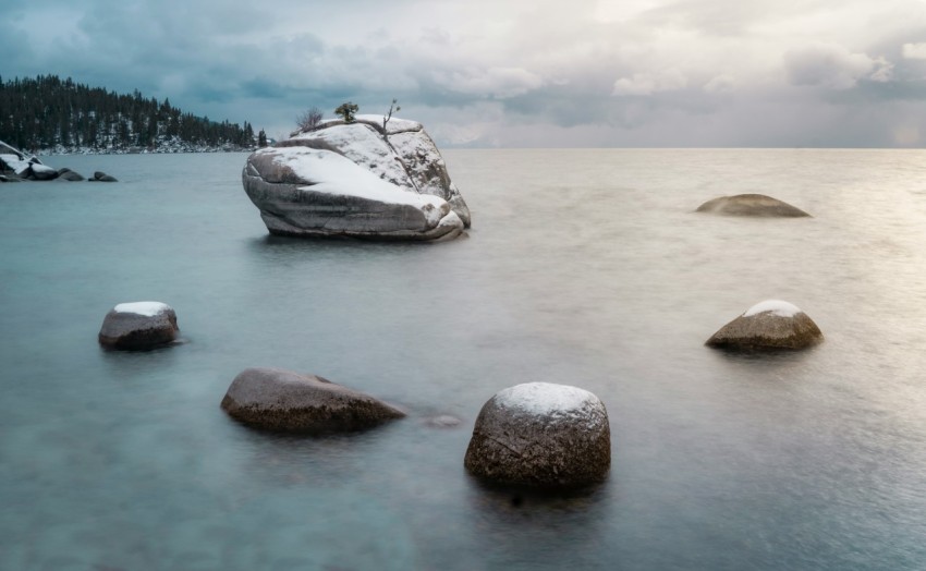 gray rock on body of water during daytime