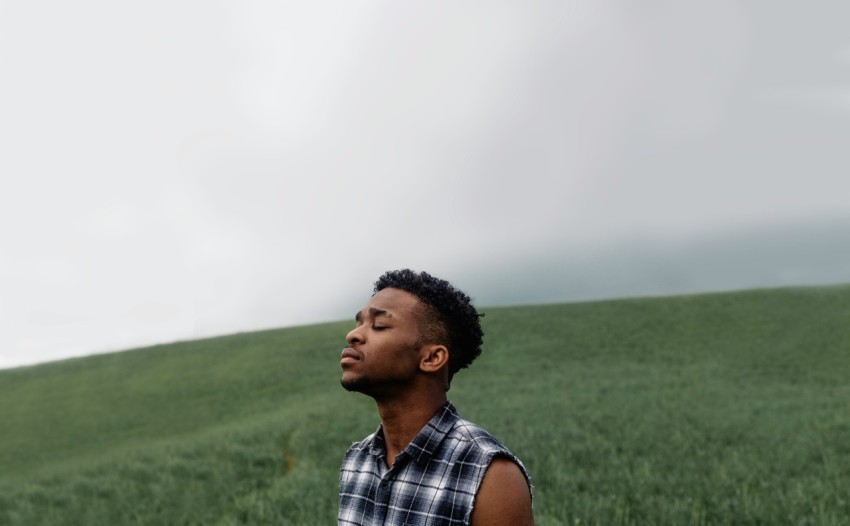 man wearing black gray and white plaid sleeveless top