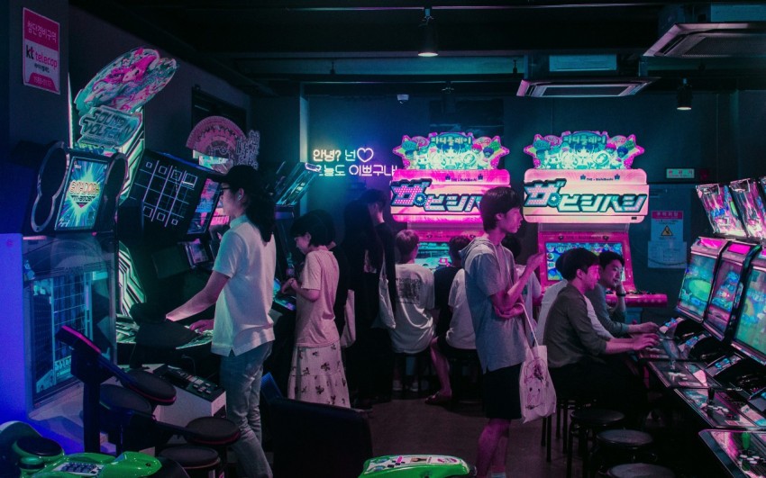 people playing arcade games