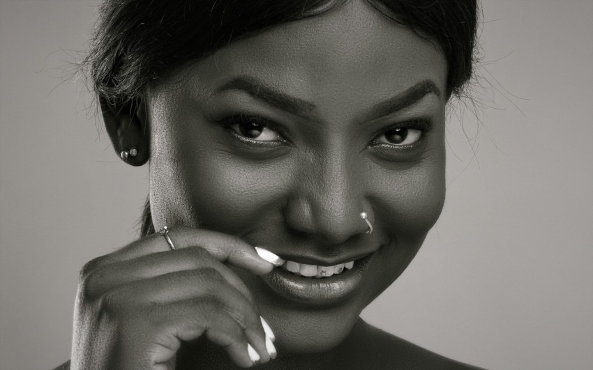 a black and white photo of a woman smiling