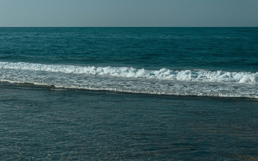 a man riding a surfboard on top of a wave in the ocean