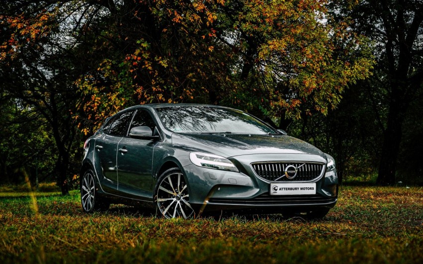 black mercedes benz coupe on green grass field during daytime