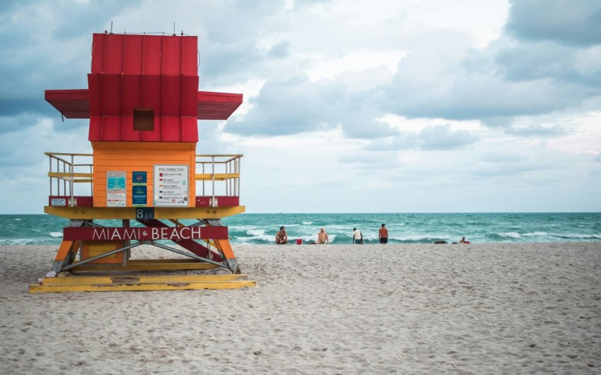 a lifeguard tower sitting on top of a sandy beach