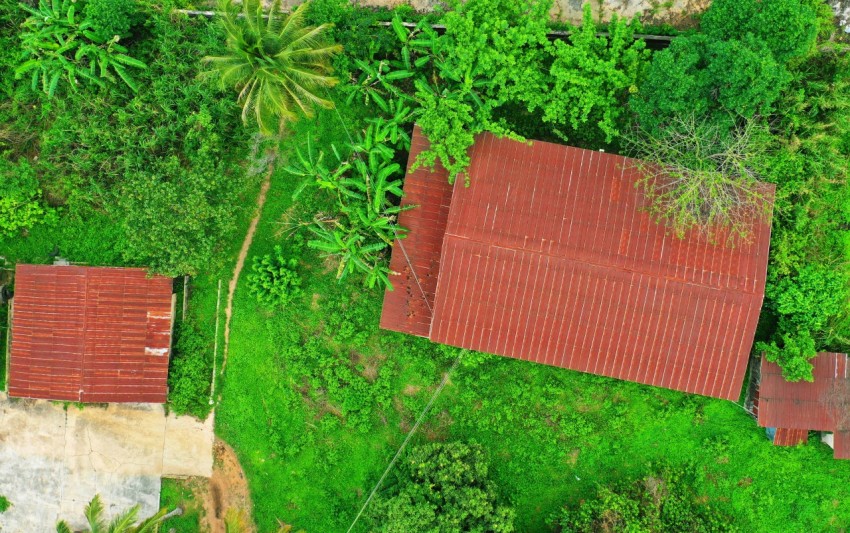 birds eye photography of red galvanized iron sheet house