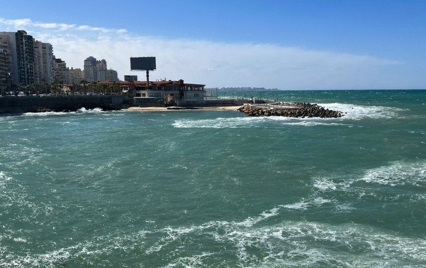 a body of water with buildings in the background