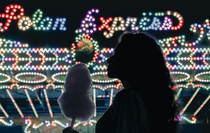 silhouette of woman standing near lighted christmas tree during night time WRS_7kxLx