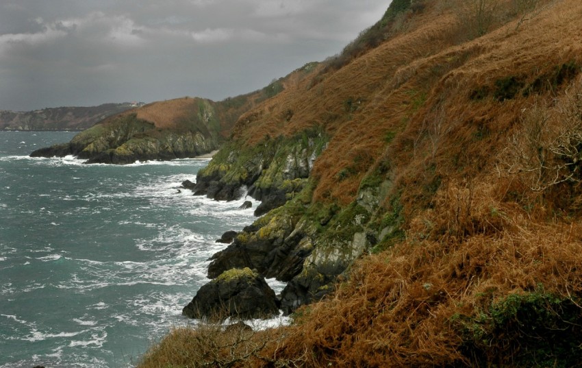 a rocky cliff with a blue sky