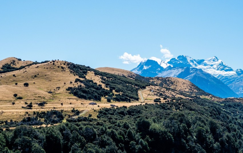 a view of a mountain range with trees and mountains in the background