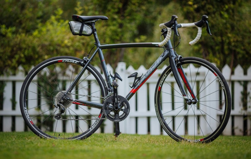 black and red fury road bike on lawn at daytime