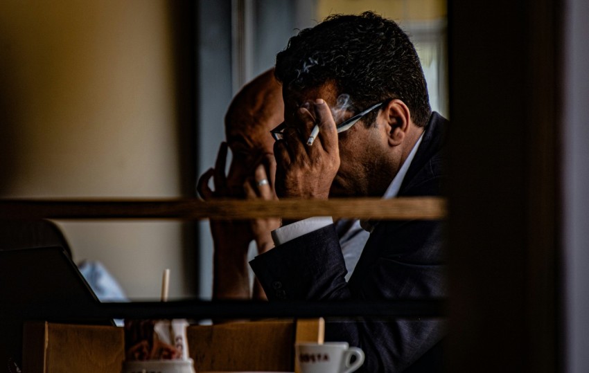 a man holding his face