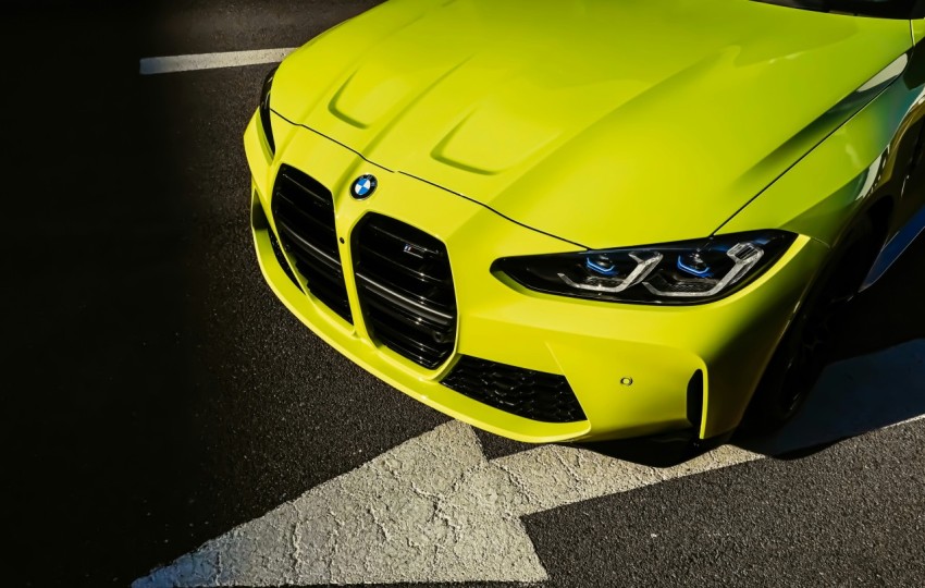 yellow mercedes benz car on gray asphalt road