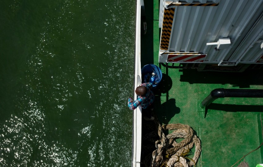 a person standing on a boat in the water