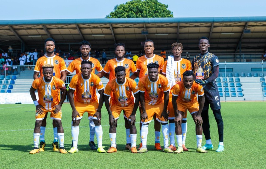 a group of men standing next to each other on a soccer field