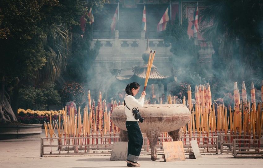 man in black vest and white shirt holding stick with blue powder