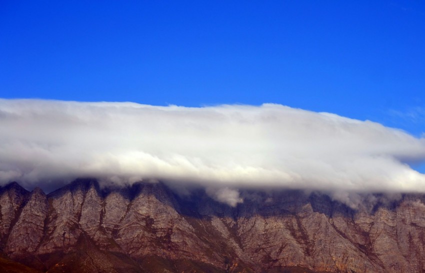 brown mountain with clouds