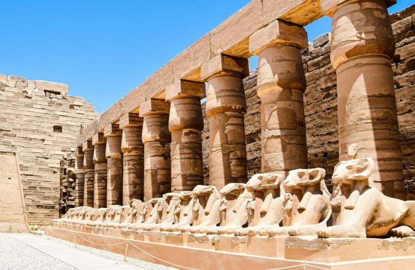 a row of statues in front of a building