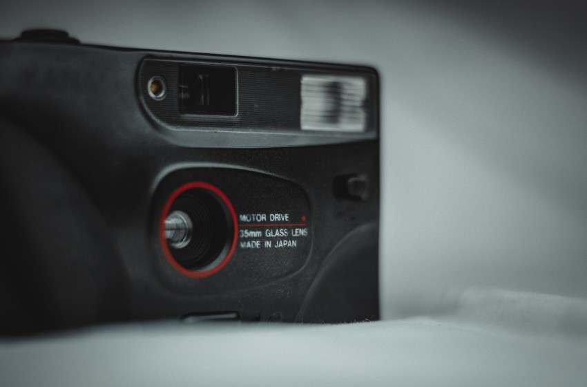 a black and red camera sitting on top of a table