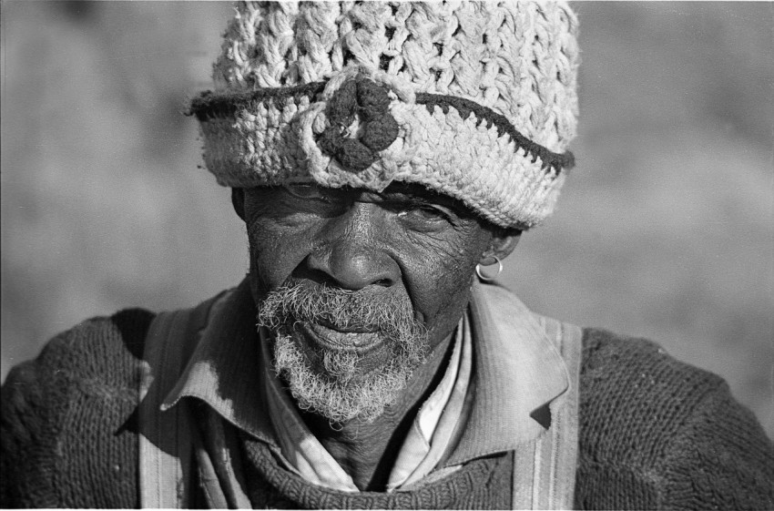 grayscale photo of man wearing knit cap