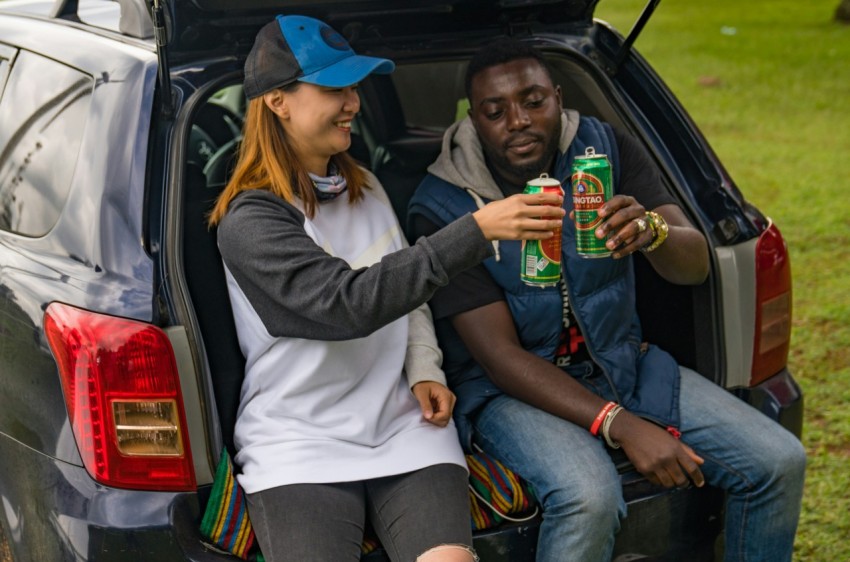 a man and a woman sitting in the back of a car