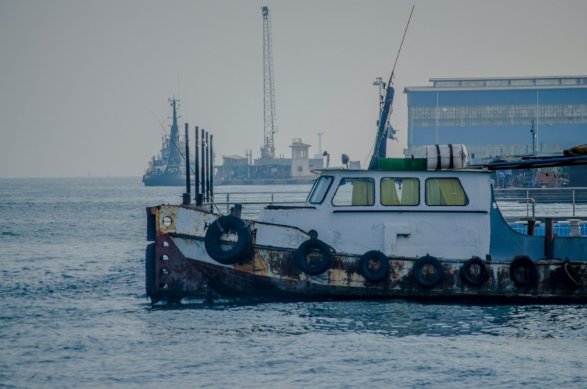 white and red boat on sea during daytime