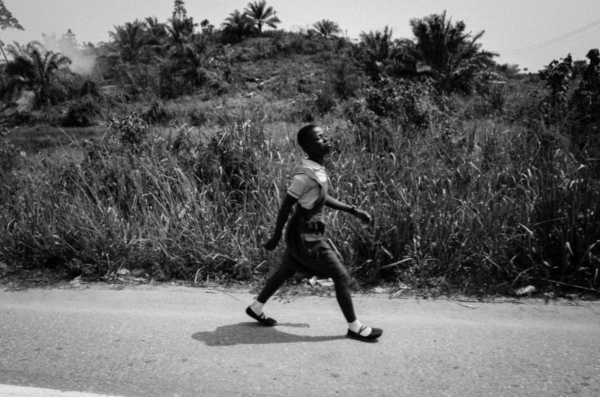 grayscale photo of boy in t shirt and shorts playing basketball