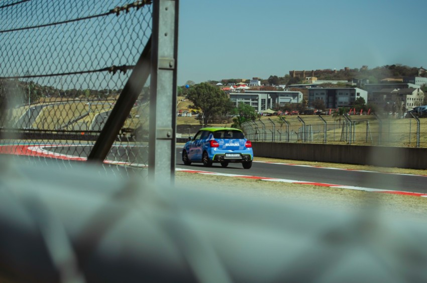 a blue car driving down a race track