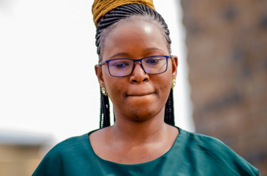 a woman with glasses and a braid in her hair