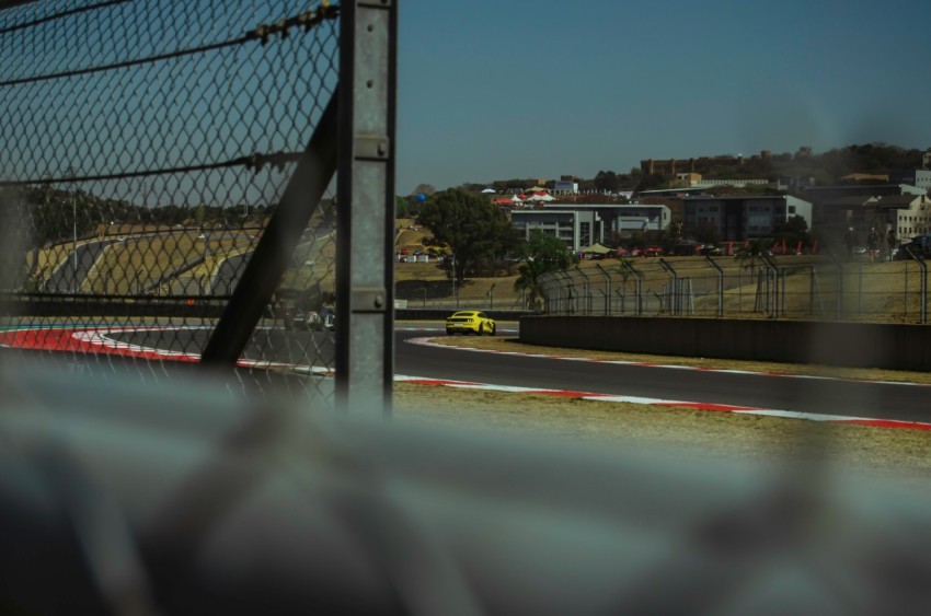 a view of a race track from behind a fence