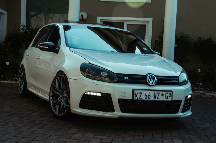 a white car parked in front of a building